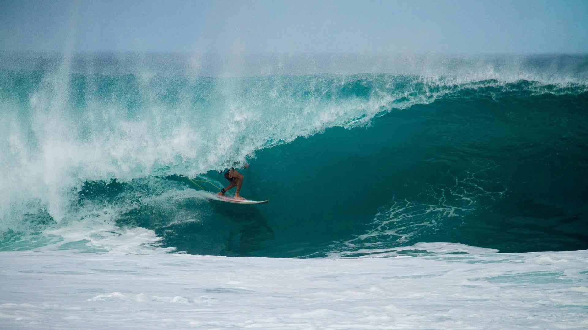 surfer getting tubed
