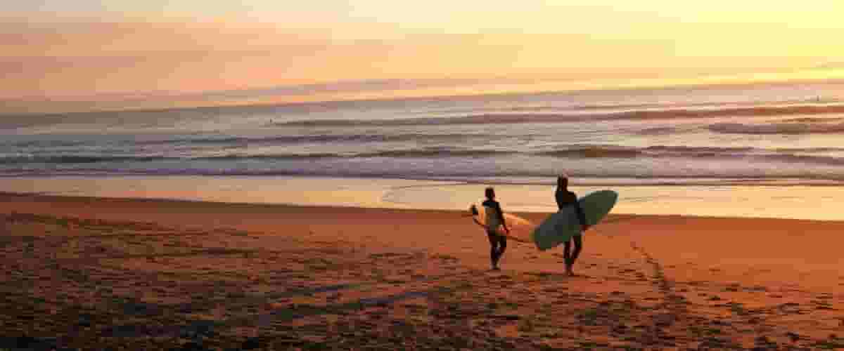 surfers on beach in Portugal