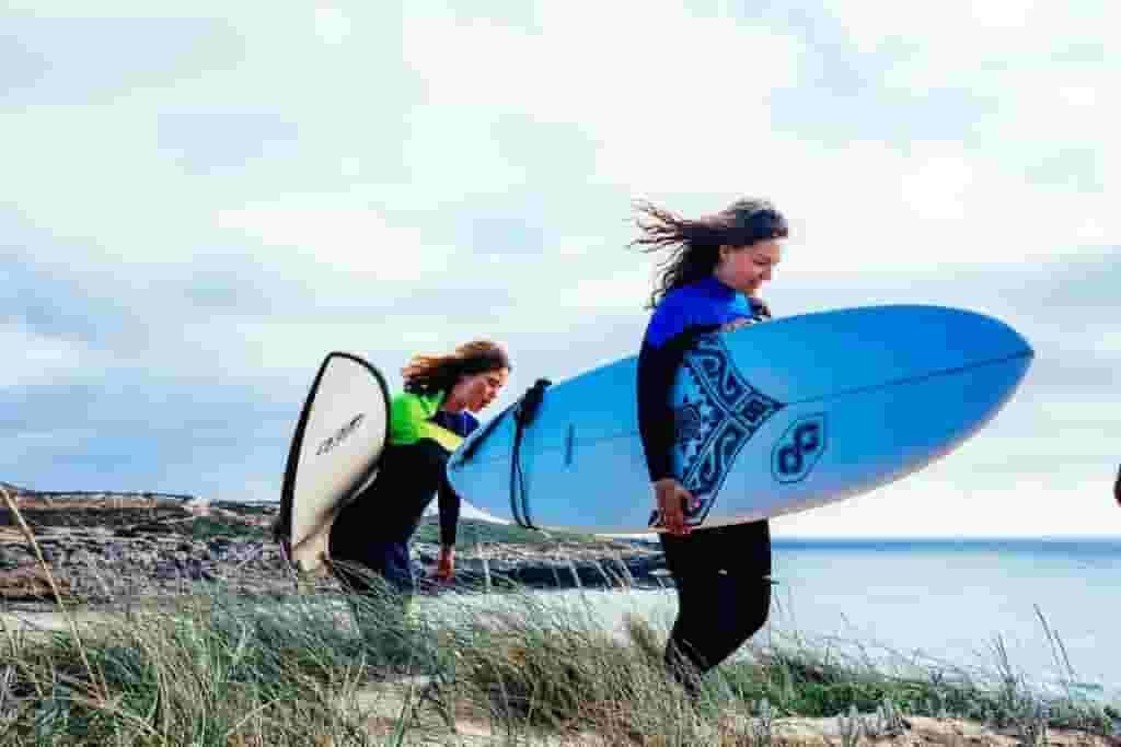 surfers heading for a surf