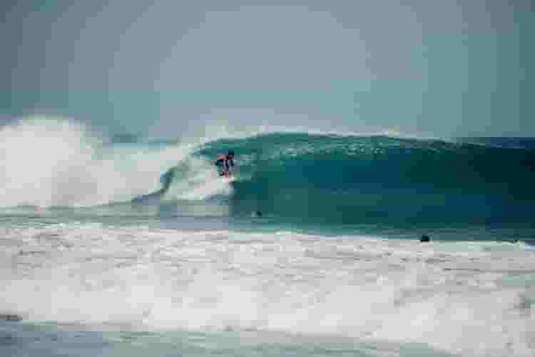 surfer getting barreled