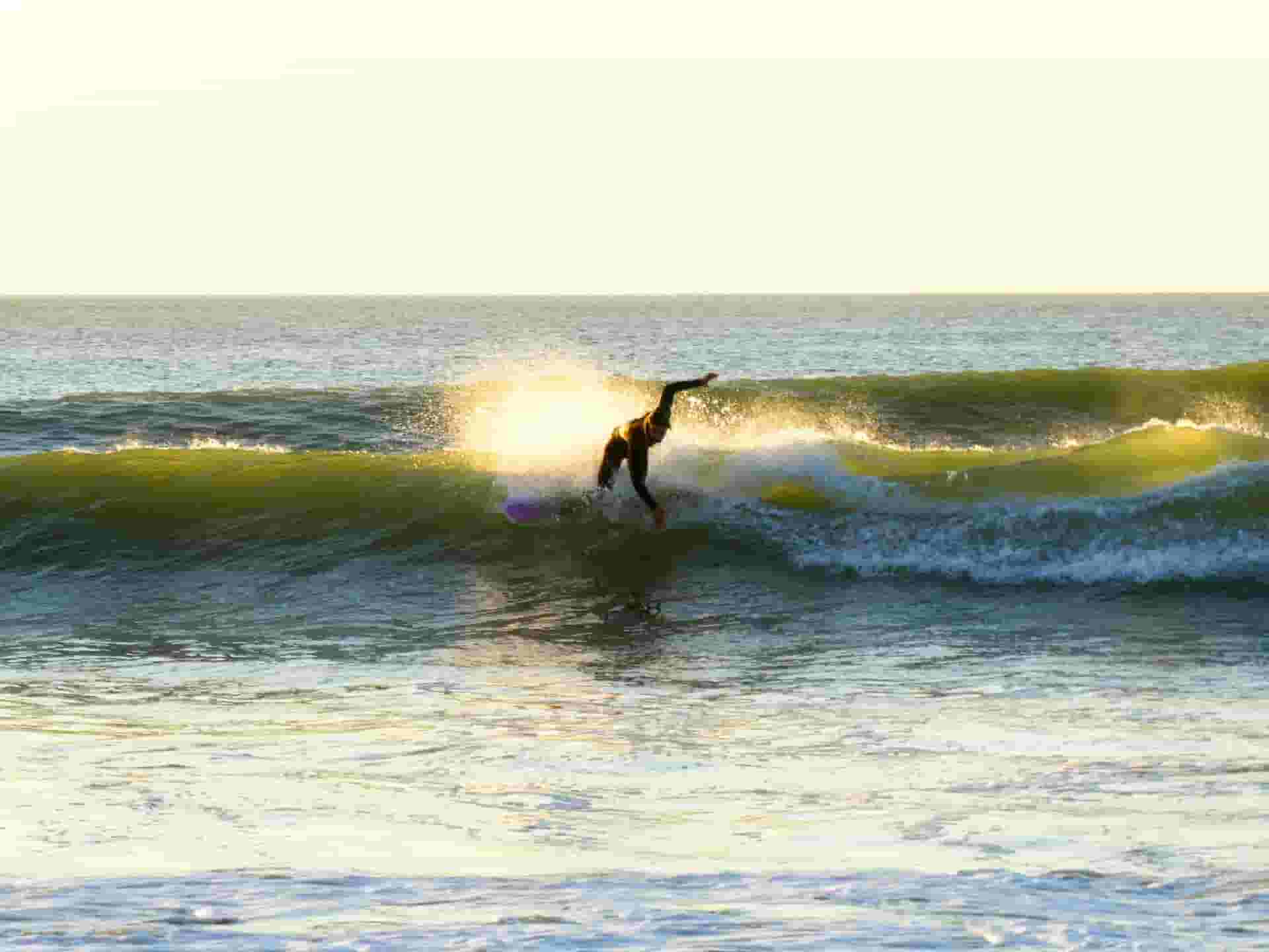 surfer ripping the waves