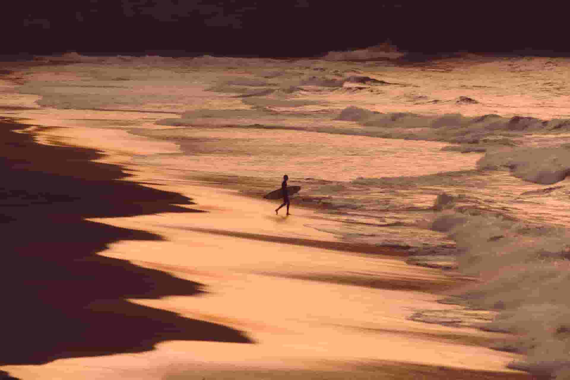 lonely surfer on beach