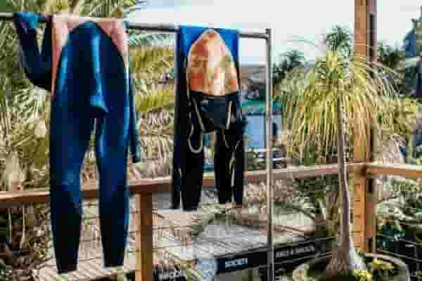 wetsuits on the rack