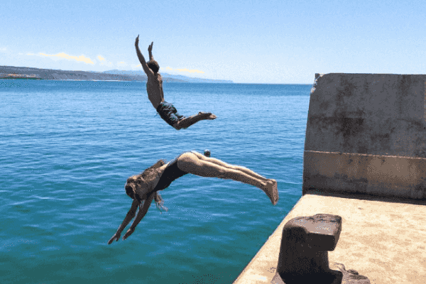 friends jumping in the water