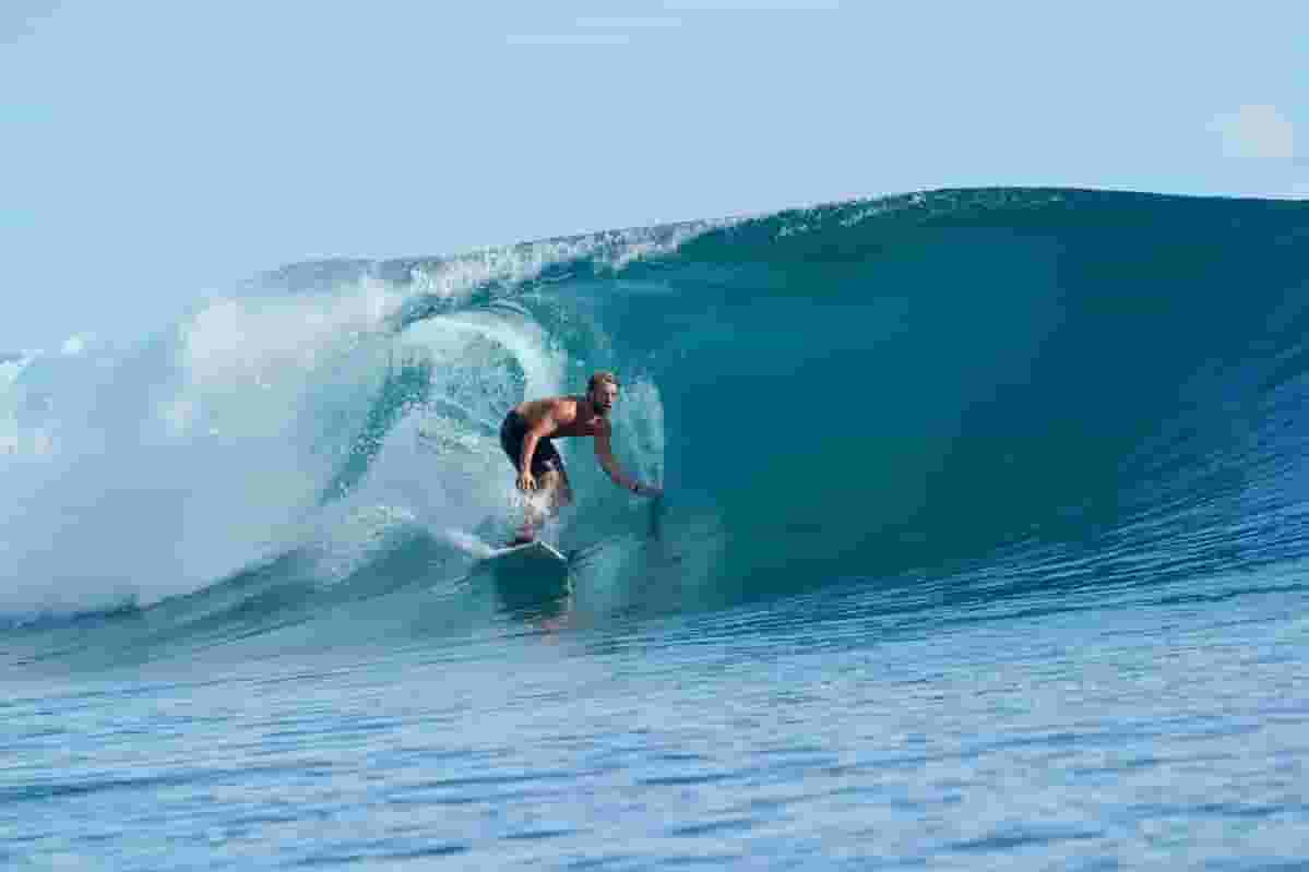 surfer catching barrel
